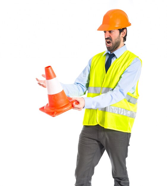 Workman holding a traffic cone