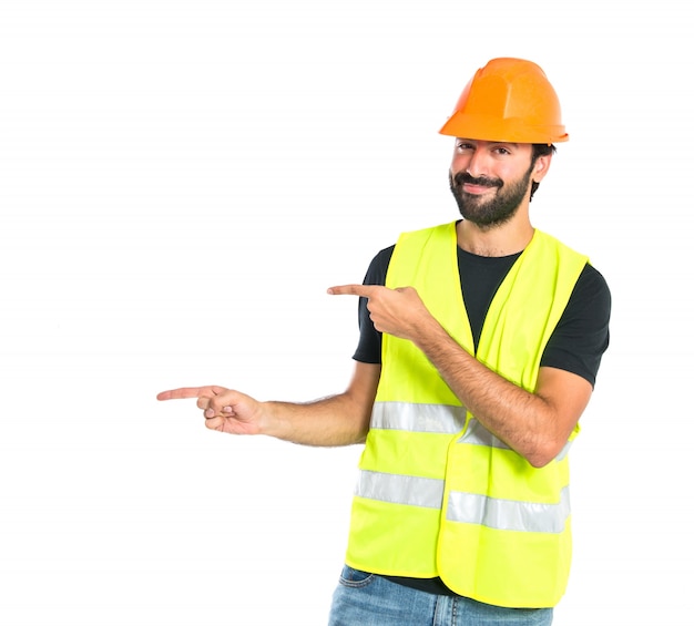 Free photo workman pointing to the latertal over white background