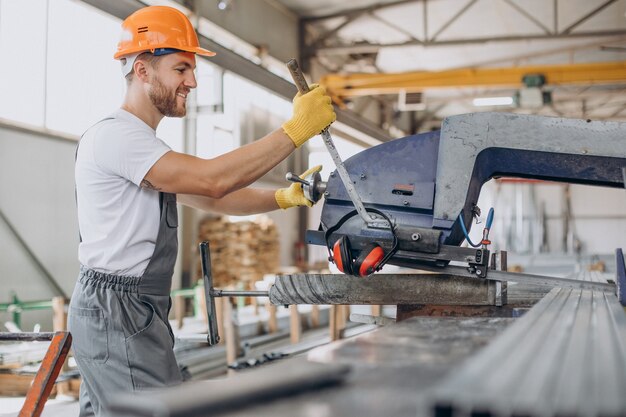 Workman at store house in orange helmet