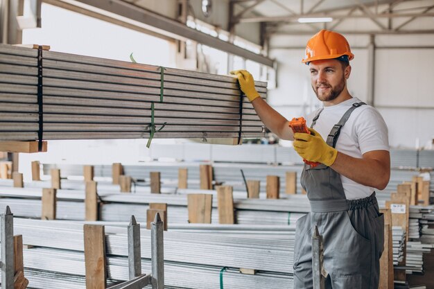 Workman at store house in orange helmet