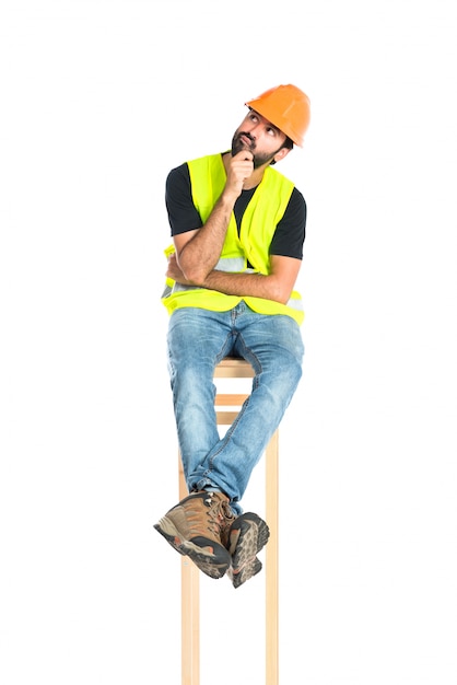 Workman thinking over isolated white background