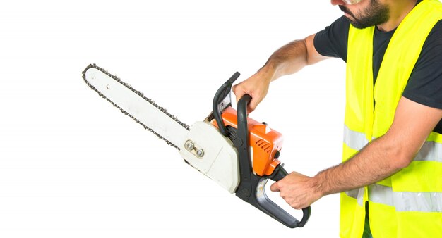 Workman with chainsaw over white background