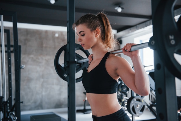 Workout routine. Photo of gorgeous blonde woman in the gym at her weekend time