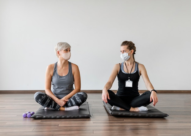 Workout with personal trainer lotus position front view