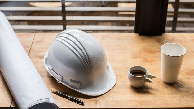 Workplace of architect - Architectural project, blueprints, blueprint, coffee cup. Engineering tools and gadgets view from the top. Construction background. vintage warm toned image with morning light.