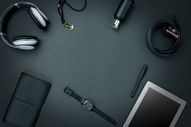Workplace of business. Modern male accessories and laptop on black background