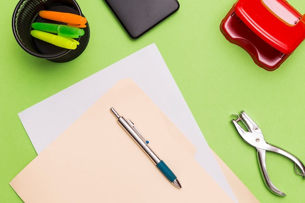 Workplace of green desk with office tools 