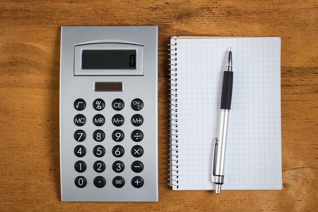 Workplace. Notepad and calculator on the table