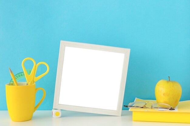 Workplace for studies in blue and yellow colors with gray photo frame