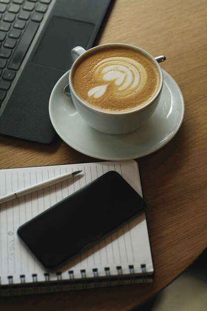 Workplace with coffee cup and laptop