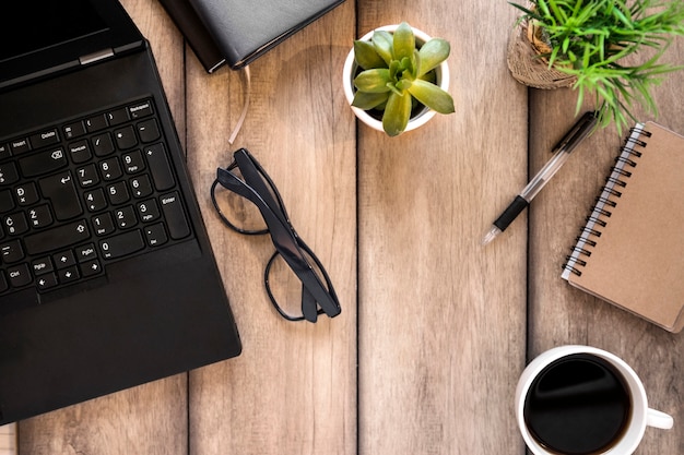 Free photo workplace with laptop glasses and coffee