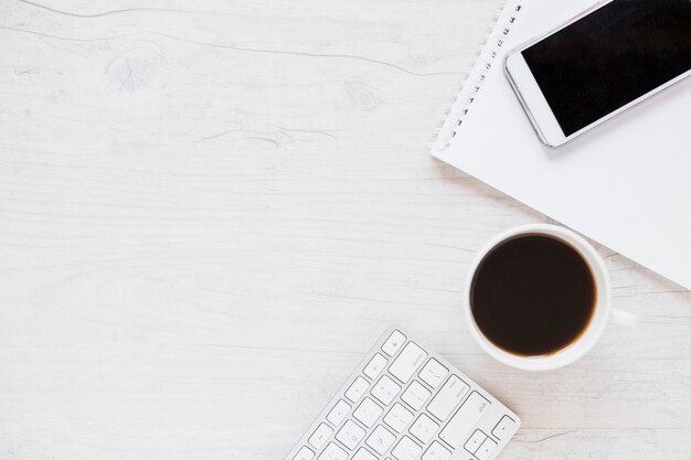 Workplace with notebook smartphone and coffee