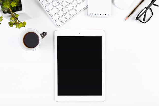 Workplace with tablet and coffee cup