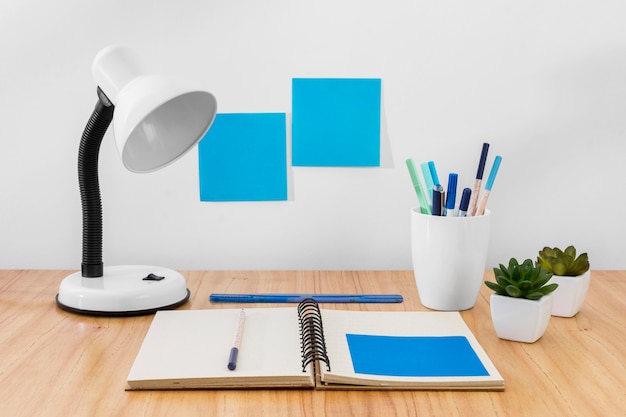 Free photo workspace arrangement with desk lamp