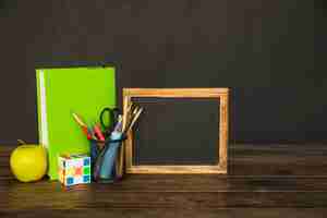 Free photo workspace with blackboard book and stationery