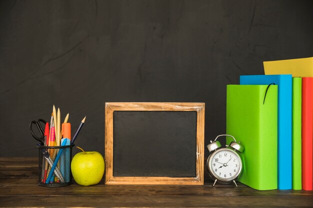 Workspace with books and blackboard frame