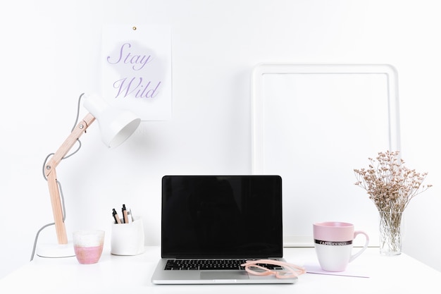 Workspace with laptop mug and stationery