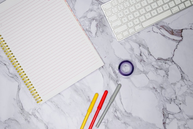 Free photo workspace with office supplies on marble surface