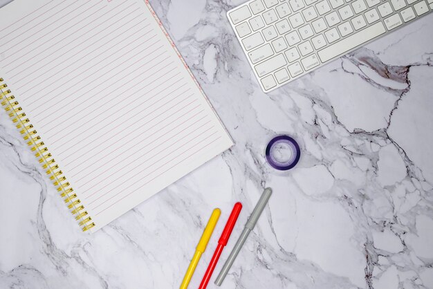 Workspace with office supplies on marble surface
