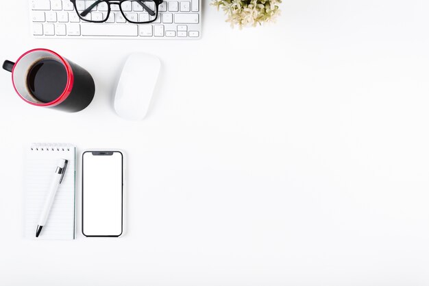 Workspace with smartphone mug and keypad