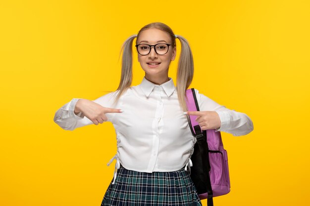 World book day happy cheering student in uniform pointing at herself with pink backpack