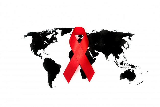 World cancer day : Breast Cancer Awareness Ribbon on world map .