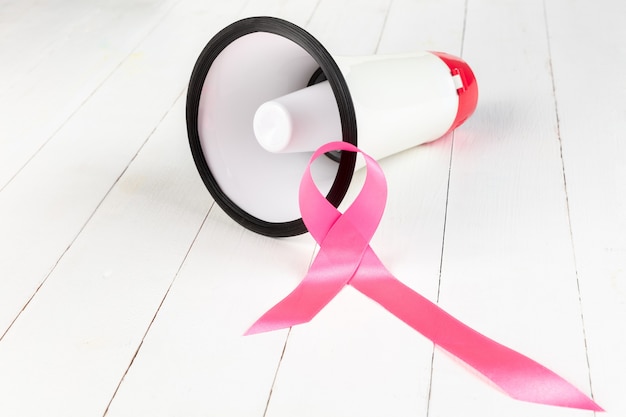 World cancer day with pink ribbon and megaphone