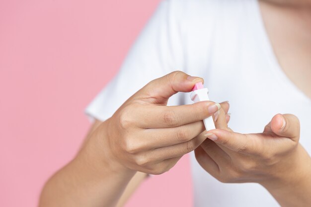 World diabetes day; close up picture of using medical device for check glucose in the blood.