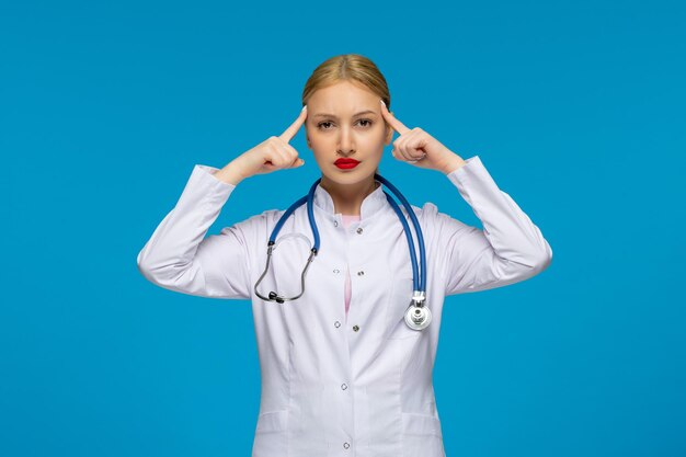 World doctors day tired doctor holding temples with the stethoscope in the medical coat