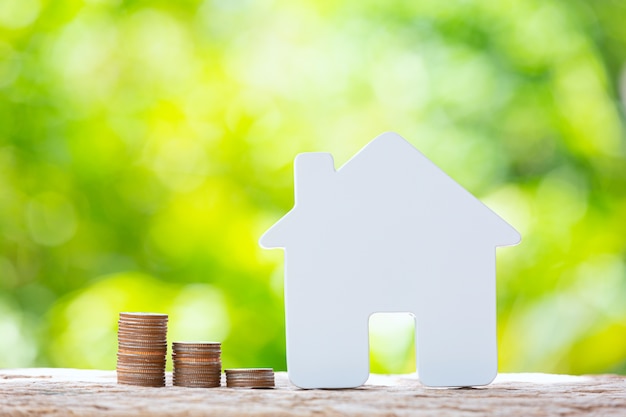 World Habitat Day,close up picture of a pile of coins and a model house