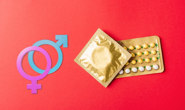 World sexual health male female gender signs condom on wrapper pack and contraceptive pills