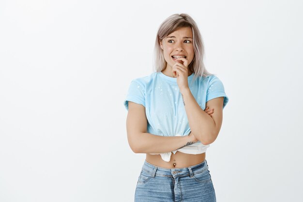 worried blonde girl posing in the studio