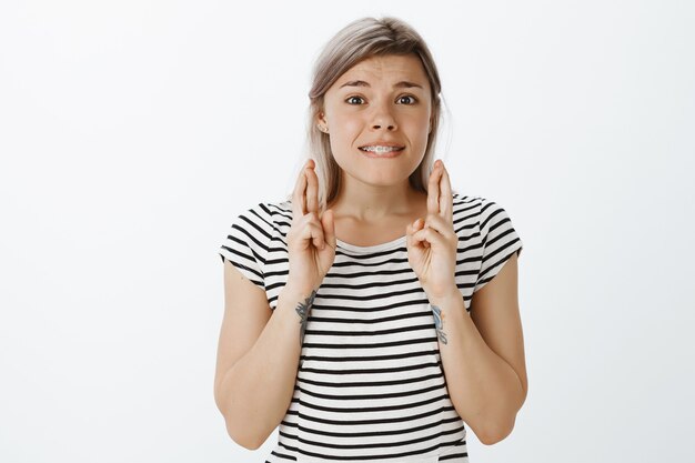 Worried blonde girl posing in the studio