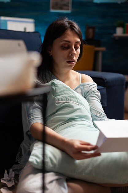 Worried desperate frustrated depressed young woman reading invoice bank