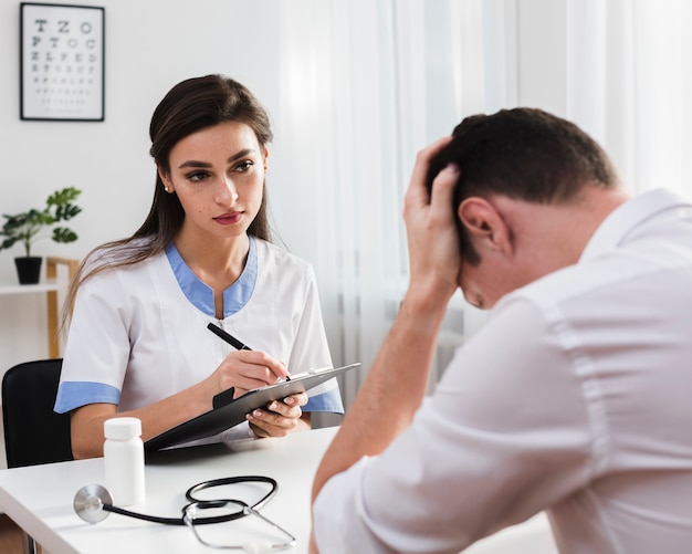 Worried doctor looking at sad patient