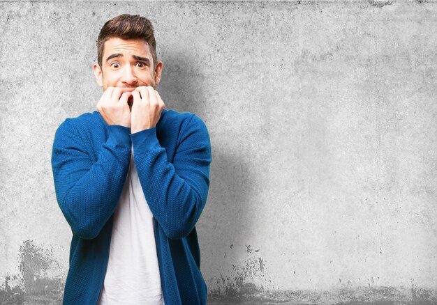 Worried man biting his nails