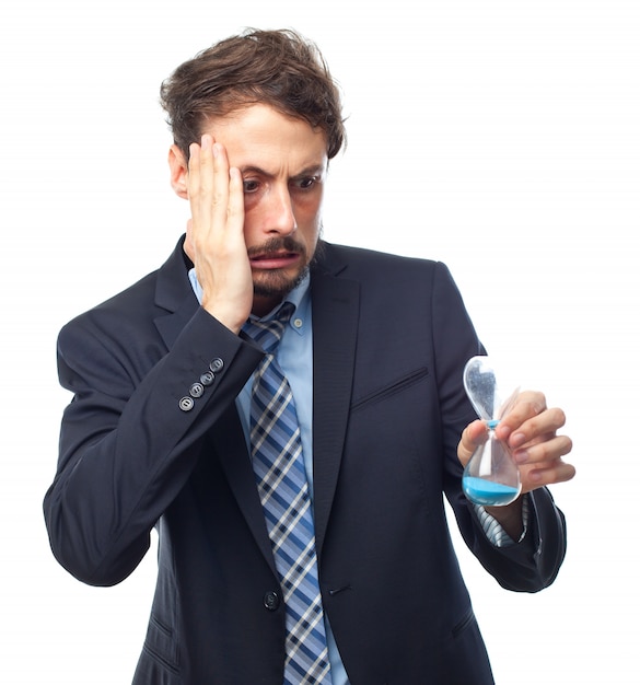 Free photo worried man looking at an hourglass