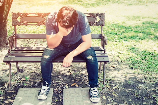 Free photo worried man sitting on a bench