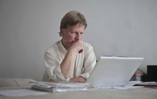 Free photo worried man works on the computer