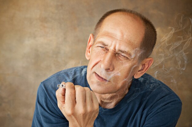 Worried mature man smoking