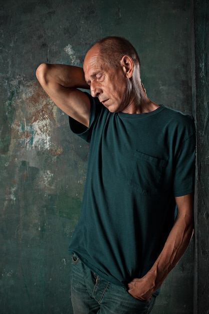 Worried mature man standing at studio