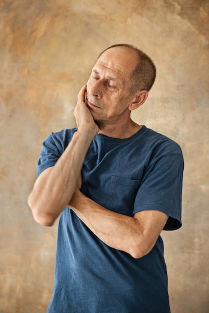 Worried mature man touching his head.