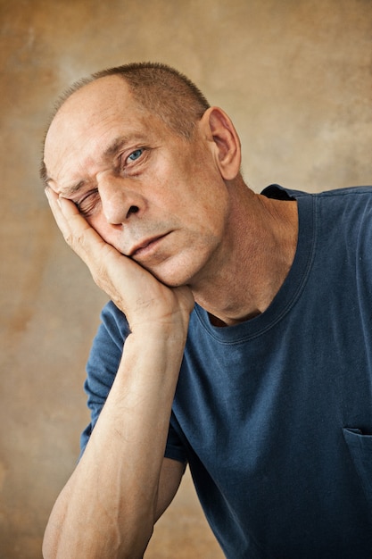 Worried mature man touching his head.