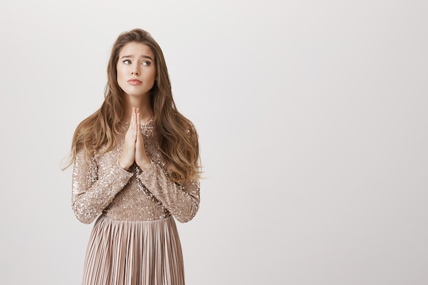 Worried pleading girl in evening dress