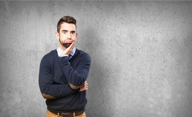 Worried teenager with a hand on his face