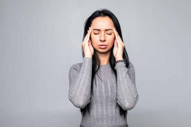 Worried woman portrait isolated over white wall