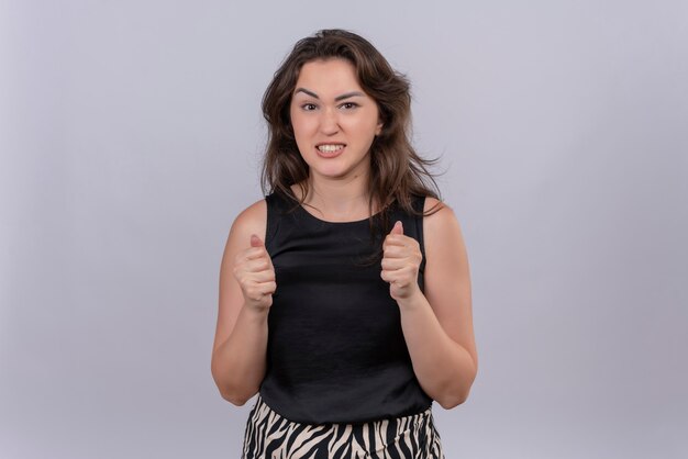 Worrying caucasian young girl wearing black undershirt on white background