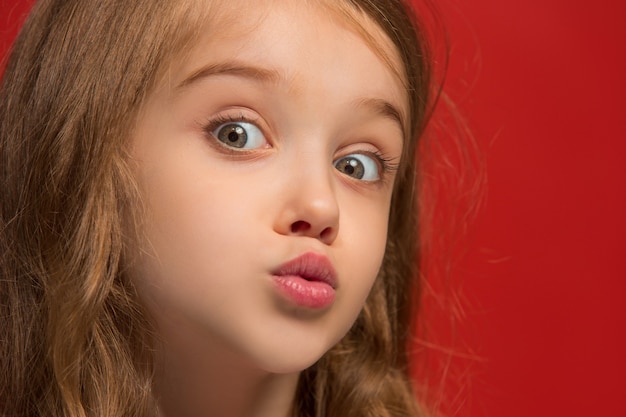 Wow. Beautiful female front portrait isolated on red studio backgroud