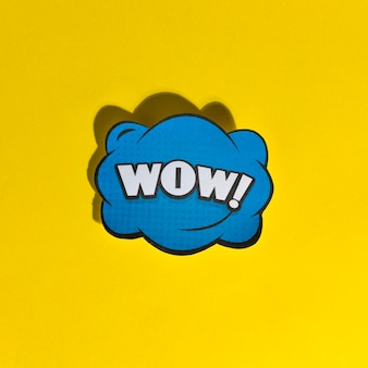 Wow word pop art retro vector illustration on yellow background