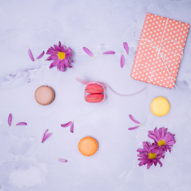 Wrapped gift with purple flowers and macarons